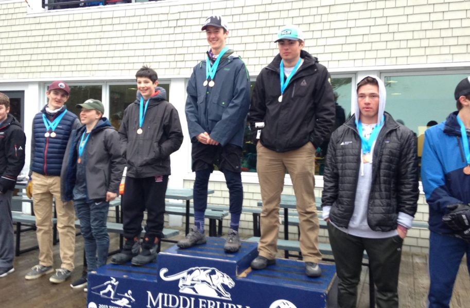 Ski racer Dylan Roussel on the podium at Vermont High School State Championships.